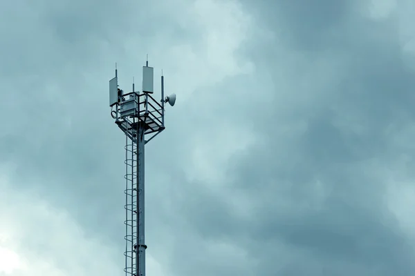 Cellular tower on the blue sky background