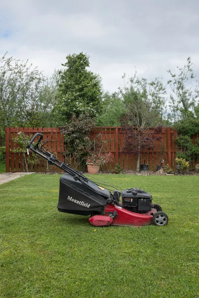 Cramlington, Northumberland, UK 25 MAY 2015. Lawn mower in garden