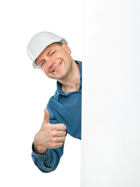 Man in a construction helmet shows gesture OK