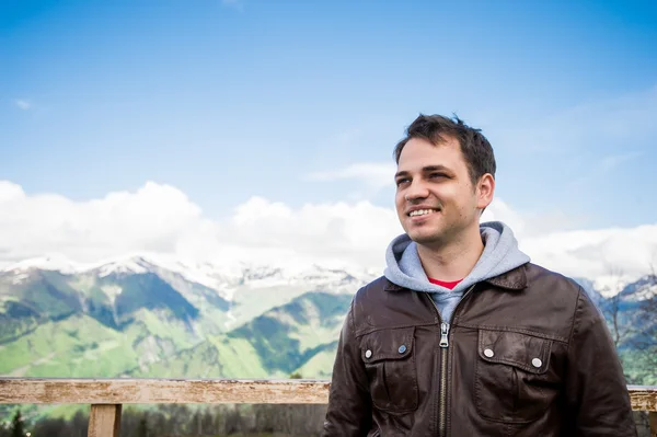 Happy smiling man hiking at the mountains