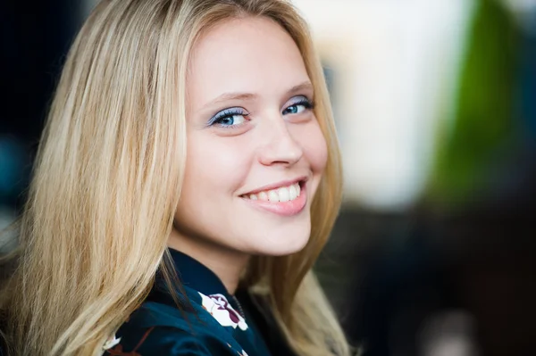 Woman smiling with perfect smile white teeth in a park and looking at camera