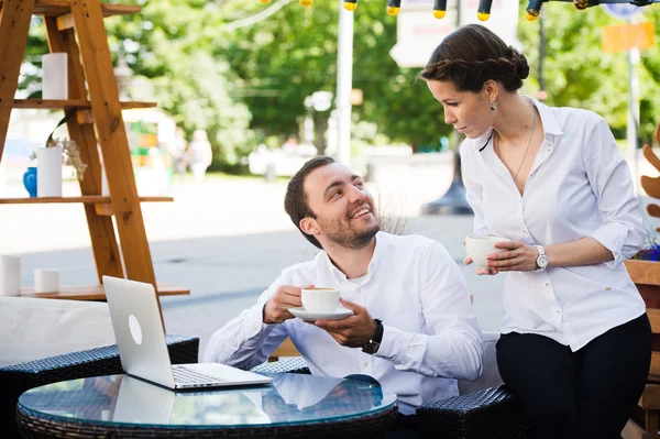 Happy business people on their lunch outside at the coffee shop