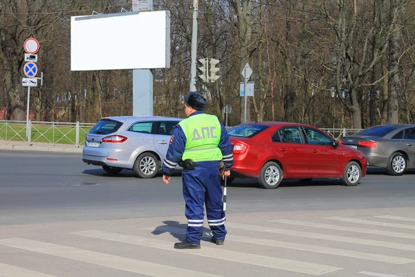 The traffic police officer costs at the crosswalk