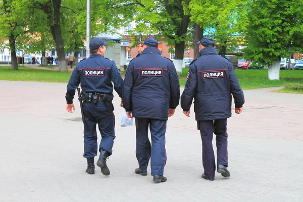 Three policemen, seen from behind