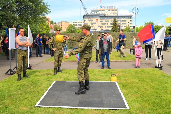 Soldiers employees carry out power exercises with weights