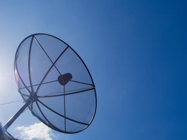 Satellite Dish Transmission Data On Bright Blue Sky Background.