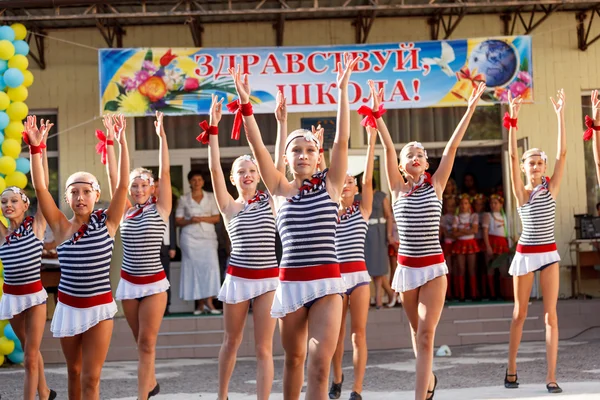 Odessa, Ukraine - September 1, 2015: School line is in schoolyard. The Knowledge Day in Ukraine, School dance group