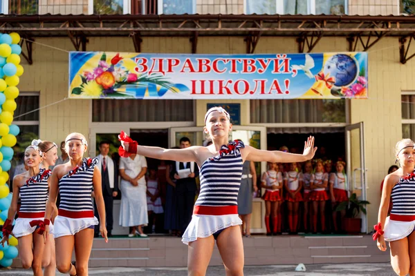 Odessa, Ukraine - September 1, 2015: School line is in schoolyard. The Knowledge Day in Ukraine, School dance group
