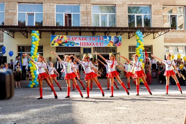 Odessa, Ukraine - September 1, 2015: School line is in schoolyard. The Knowledge Day in Ukraine, School dance group