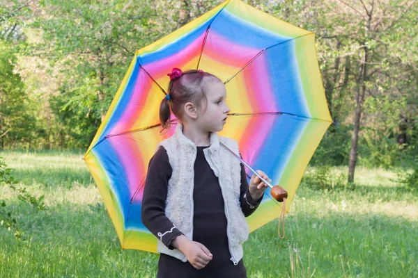 The girl with a multi-colored umbrella.
