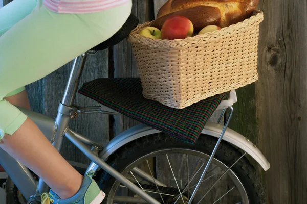 Bicycle basket with apples.
