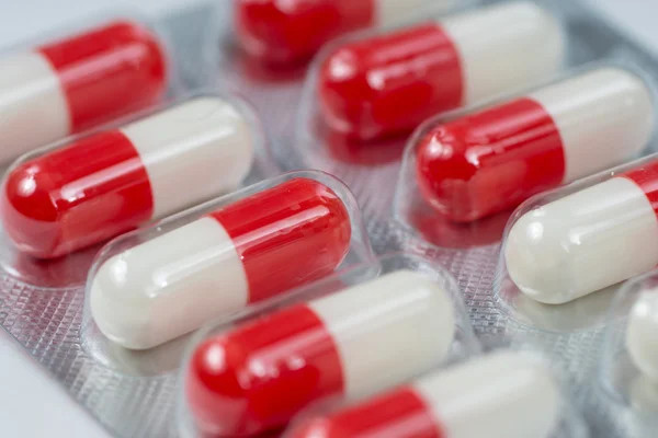 White and red antibiotic capsules