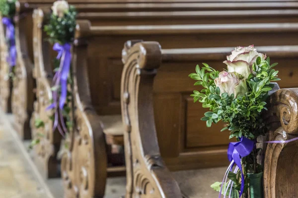 Church pew details with floral wedding  decoration