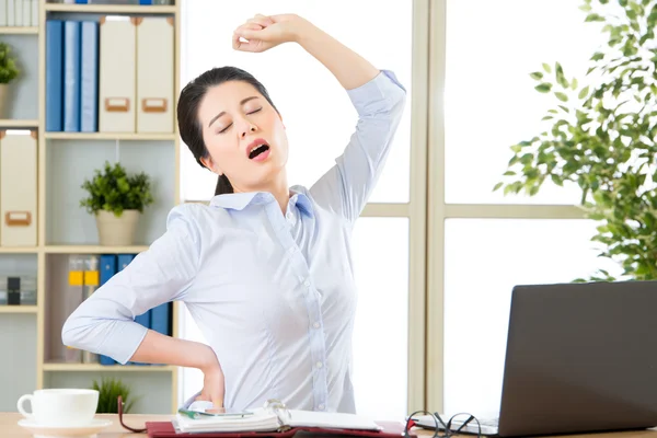 Asian businesswoman fell tired and stretching