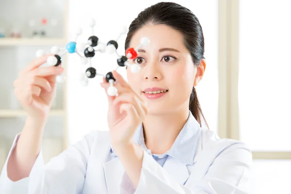 Asian female scientist Examining the building blocks of life