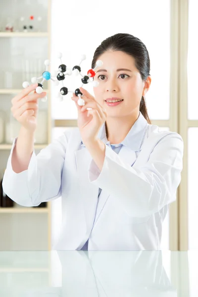 Asian female scientist Examining the building blocks of life