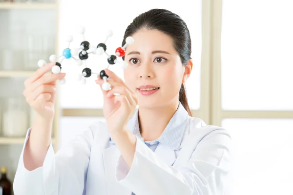 Asian female scientist Examining the building blocks of life