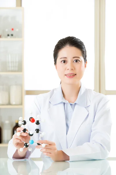 Asian female scientist Examining the building blocks of life