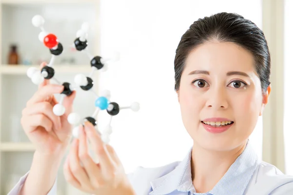 Asian female scientist Examining the building blocks of life