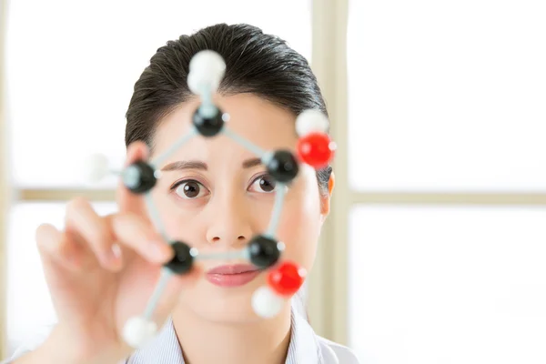 Asian female scientist Examining the building blocks of life