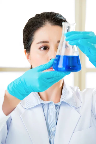 Asian female forensic scientist working on chemicals