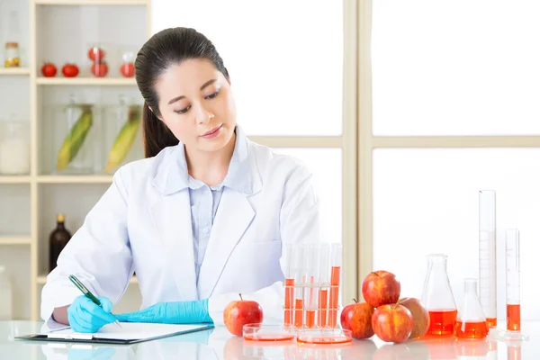 Asian female scientist recording research data for genetic modif