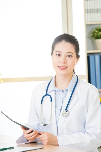 Doctor using digital tablet to research patient's medical case