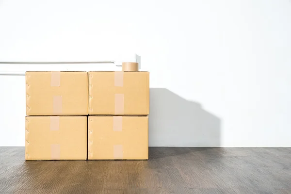 Pile of cardboard boxes on white background with box shadow