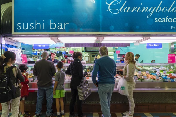 Customers queue up to buy seafood in a store