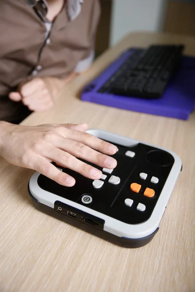 Blind person using audio book player for visually impaired