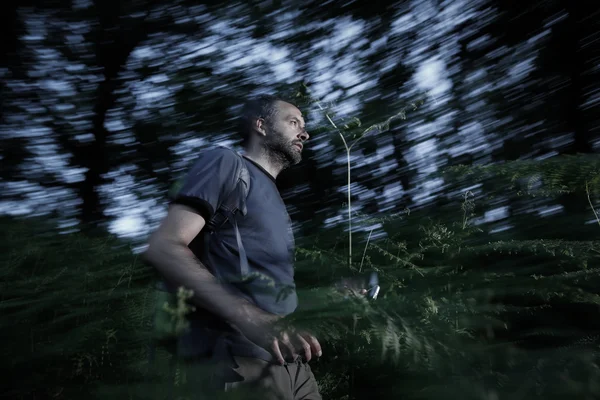 Lost man running through the woods