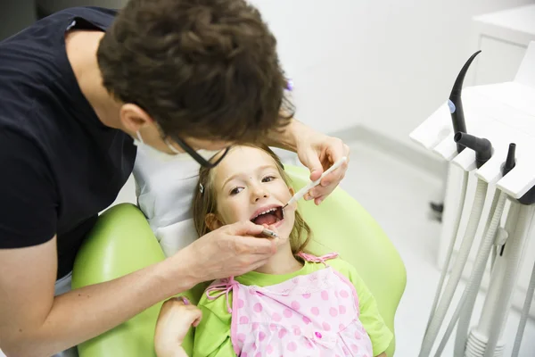 Girl sitting on dental chair on her regular dental checkup