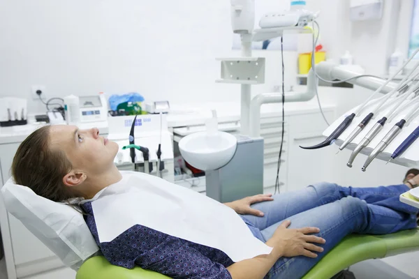 Patient sitting on dental chair