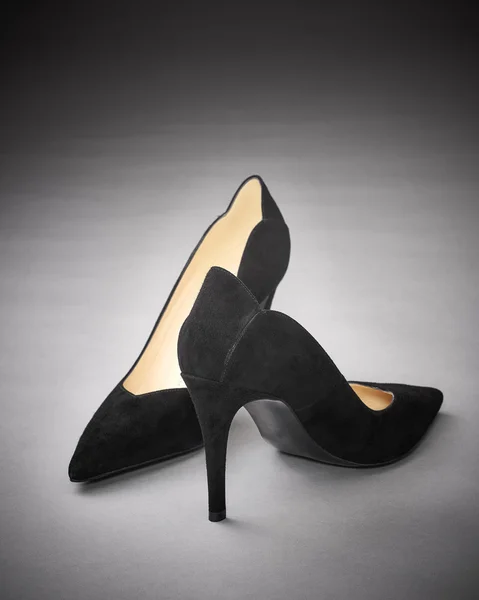 Female pump shoe on gray background.
