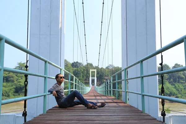 The suspension bridge over the river and Man