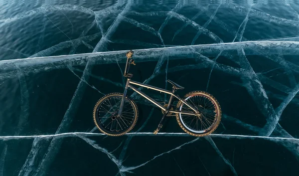 Girl on a bmx on ice.