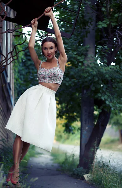 Woman in stylish skirt and crop top