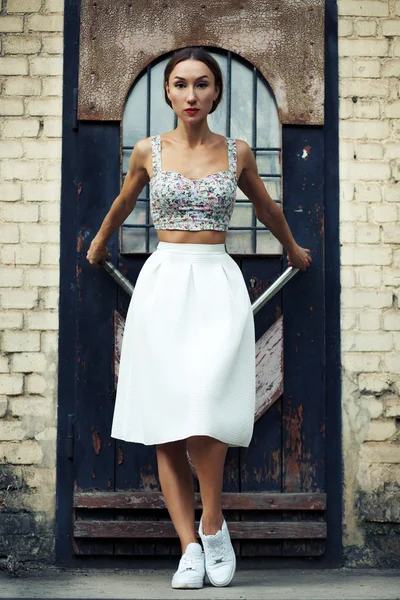 Woman in stylish skirt and crop top
