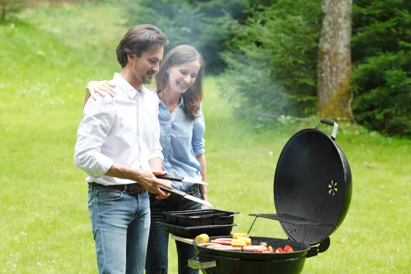 Couple cooking on barbecue