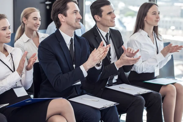 Business people clapping hands