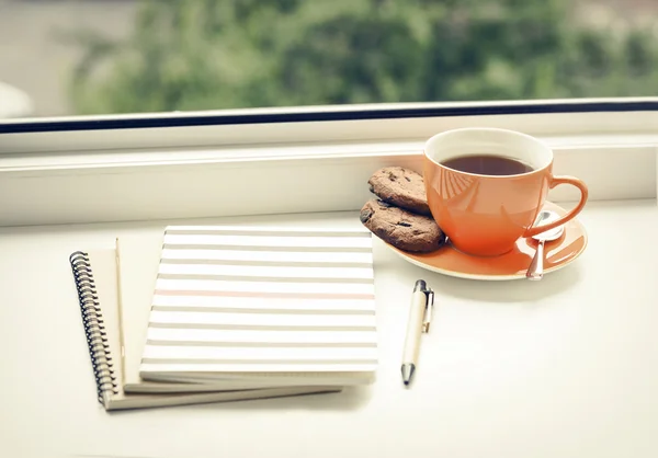 Cup of tea on the window.