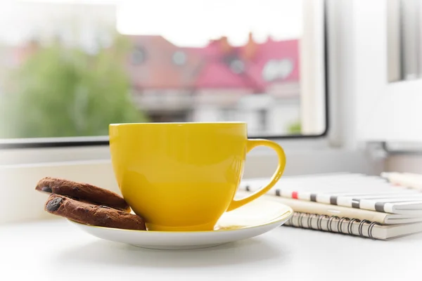 Cup of tea on a window.