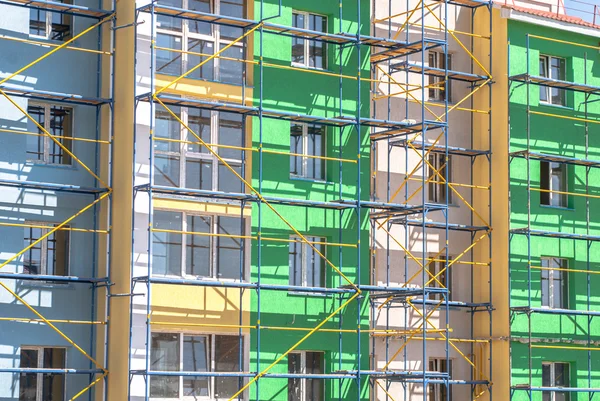 Scaffolding for finishing work the walls of a multistory building