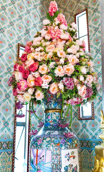 Beautiful rose pink flowers in vase in Wt Traimit. Bangkok, Thai