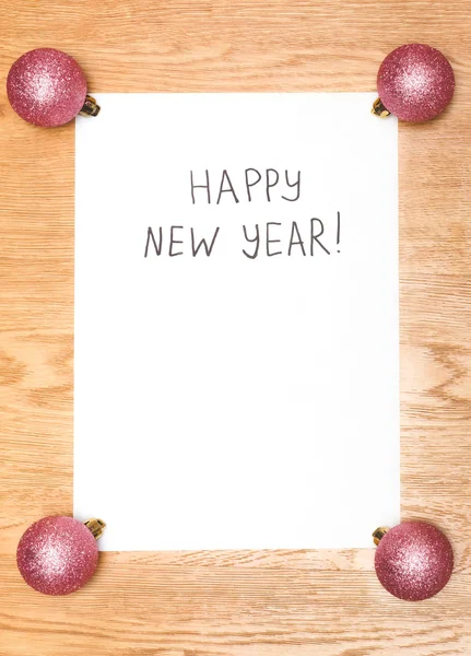 Happy New Year message greeting written on a white paper with ne