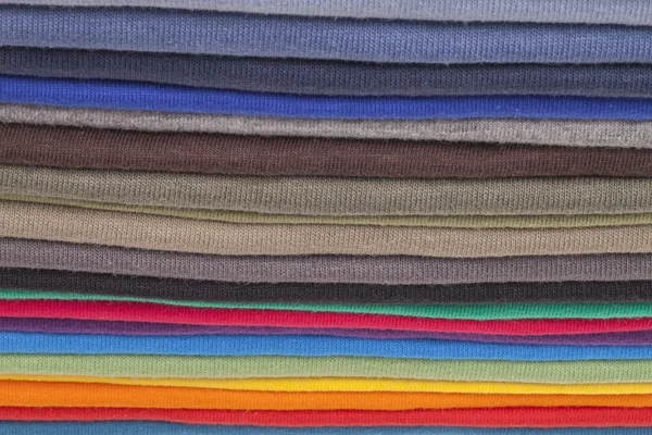 A stack of colourful shirts