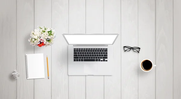 Interior architect work on laptop with isolated display for mock up. Paper, divider, wrinkled paper, glasses, ruler on desk.