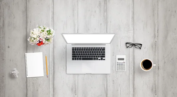 Financial management on laptop with isolated display for mock up. Calculator, paper, wrinkled paper, glasses, pencil, plant on desk.