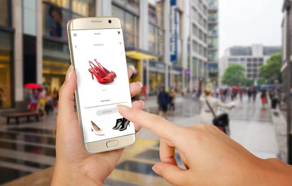 Online shopping with smart phone. Phone in woman hand. Buying women shoes on online store. Street walk and visiting shopping malls.