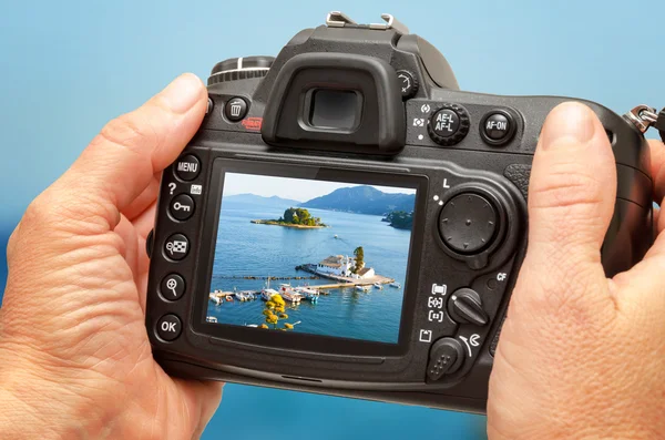 Photo of church and sea on camera display during the summer vacation. Travel photography.